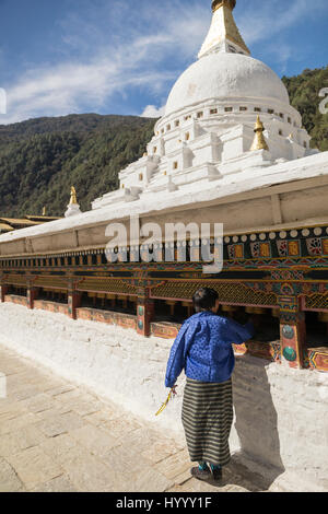 Bhutanese woman turning prayer wheels (Bhutan) Stock Photo