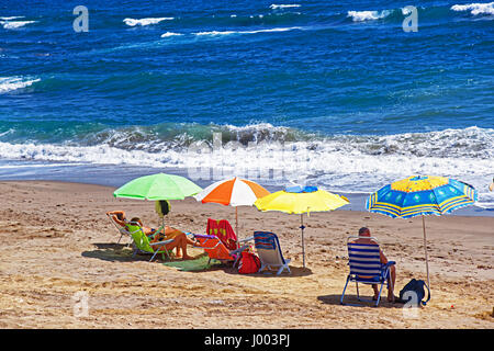 People sunbathing on the beach in the Mediterranean Sea in Marbella, Andalusia, Spain Stock Photo