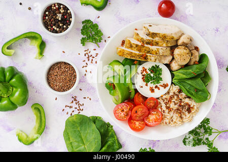 Diet menu. Healthy lifestyle. Oatmeal porridge,  chicken fillet and fresh vegetables - tomatoes, spinach, paprika,  mushrooms and yogurt  on plate. To Stock Photo