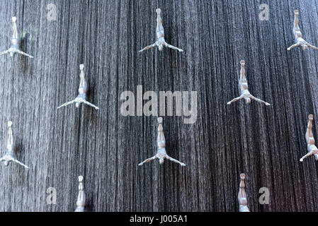 silver male sculpture installed to create a jumping effect on the fountain of Dubai Mall in Dubai, United Arab Emirates. Stock Photo