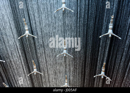 silver male sculpture installed to create a jumping effect on the fountain of Dubai Mall in Dubai, United Arab Emirates. Stock Photo