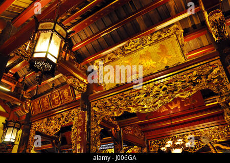 HANOI, VIETNAM - FEBRUARY 19, 2013: The golden interior of the Bach ma temple in Hanoi was decorated in the Medieval period Stock Photo