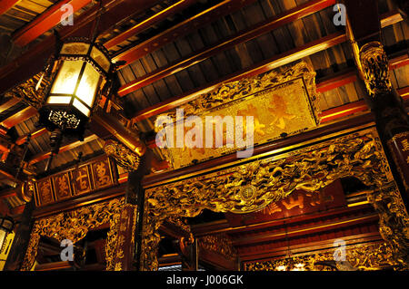 HANOI, VIETNAM - FEBRUARY 19, 2013: The golden interior of the Bach ma temple in Hanoi was decorated in the Medieval period Stock Photo