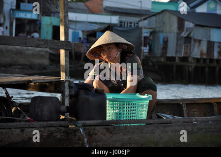 CAN THO, VIETNAM - FEBRUARY 17, 2013: Typical shack homes, riverside stils houses along the Mekong Delta. People from the suburbs are living in povert Stock Photo