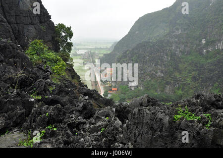 Panorama view of rice fields and limestone rocks from Hang Mua Temple viewpoint in a rainy day. Tam Coc, Ninh Binh, Vietnam Stock Photo