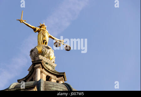 London, England - March 20, 2009: A statue of Justice stands over England's Central Criminal Court on London's Old Bailey. Stock Photo