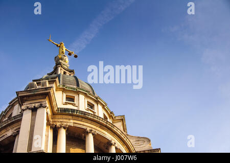London, England - March 20, 2009: A statue of Justice stands over England's Central Criminal Court on London's Old Bailey. Stock Photo