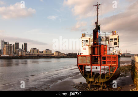 London, England, UK - March 22, 2009: A segment of a small cargo ship rests on the side of the River Thames at North Greenwich, an art installation. Stock Photo