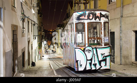 The Bica funicular tram in Lisbon, Portugal, covered in graffiti after the winter season. Stock Photo