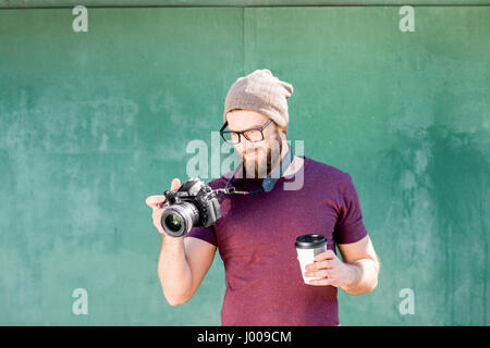 Portrait of photographer on the green background Stock Photo
