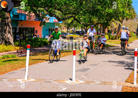 People riding their bicycles on the Fred Marquis Pinellas Trail in downtown Dunedin, Florida Stock Photo