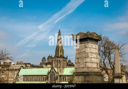 A view of Church of Scotland's Glasgow Cathedral in the city centre on a bright sunny day with blue sky and dramatic white cloud streaks Stock Photo