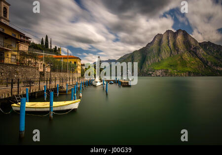 Harbor of Riva di Solto on Iseo Lake with mountains on background, Italy Stock Photo