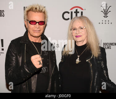 Billy Idol and Penelope Spheeris arrive for the Premiere Of 'SHOT! The Psycho-Spiritual Mantra of Rock' held at Pacific Theatres  in Los Angeles, California at The Grove on April 5, 2017. Stock Photo