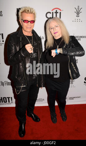 Billy Idol and Penelope Spheeris arrive for the Premiere Of 'SHOT! The Psycho-Spiritual Mantra of Rock' held at Pacific Theatres  in Los Angeles, California at The Grove on April 5, 2017. Stock Photo