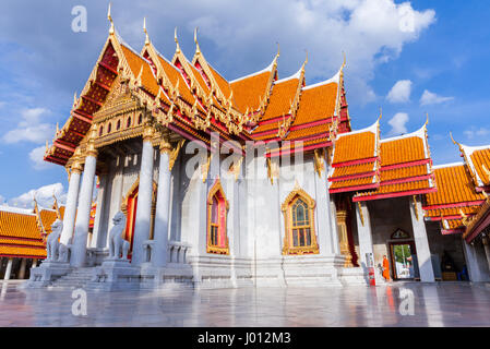 Bangkok, Thailand - September 10, 2016: Buddhist monk stands on the stairs of Wat Benchamabophit also known as Marble Temple at sunset on Septemper 10
