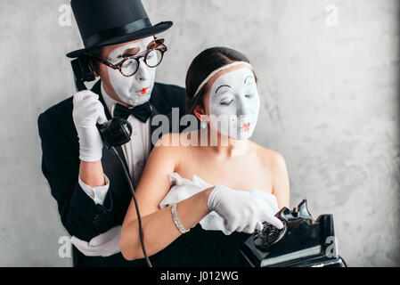 Pantomime theater actor and actress performing. Mime artists with white makeup masks on faces Stock Photo