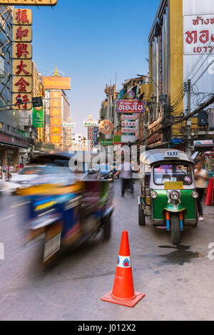 Bangkok, Thailand - April 24, 2016: Tuk-tuk taxi parked near street market in Chinatown on April 24, 2016 in Bangkok, Thailand. Stock Photo