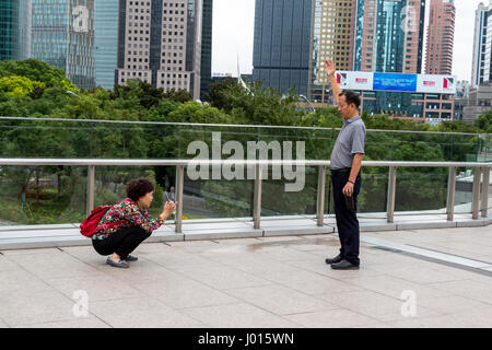 China, Shanghai.  Chinese Tourists Taking Pictures. Stock Photo