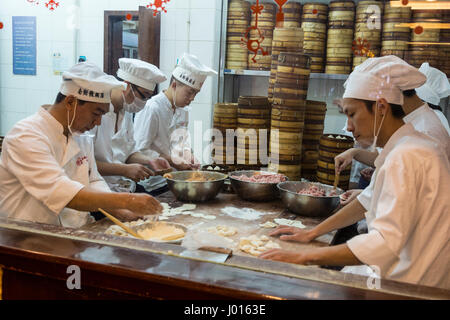 China, Shanghai.  Kitchen Chefs Making Dumpligs at Nanxiang Dumpling Restaurant, Yuyuan Garden. Stock Photo