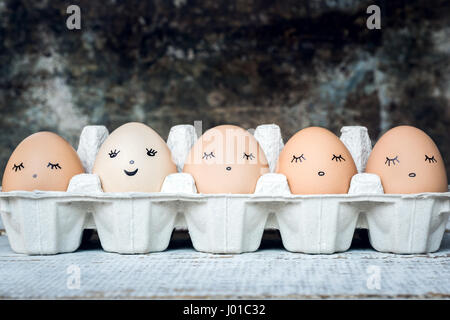 Five organic hen eggs with cute faces, bio produce background Stock Photo