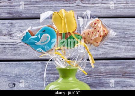 Easter biscuits wrapped in plastic. Cookies with colored glaze. Stock Photo