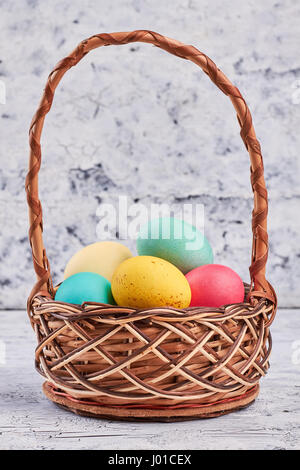 Basket with dyed eggs. Side view of Easter basket. Stock Photo