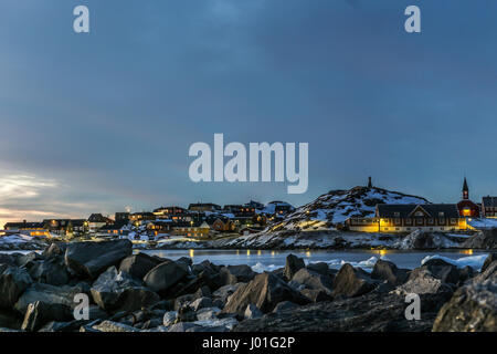 Nuuk city old harbor sunset view with stones and icebergs, Greenland Stock Photo