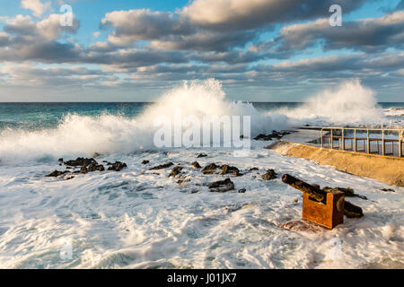 Large Ocean Waves Breaking Onto a Rocky Shoreline Stock Photo