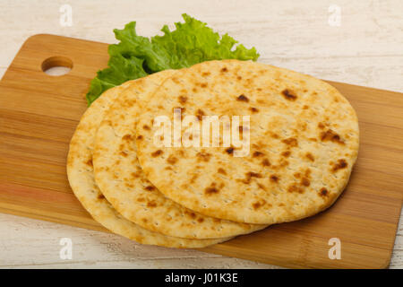 Pita bread with salad over wood background Stock Photo