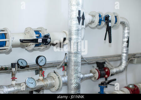 Pipes in a boiler room. Isolation of pipes. Water heating. Power water supply. Modern boiler room equipment. High power boiler burner. Water heating.  Stock Photo