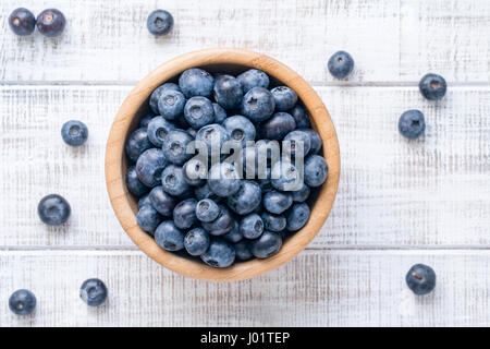 Bowl of fresh blueberries on vintage white background. Top view Stock Photo