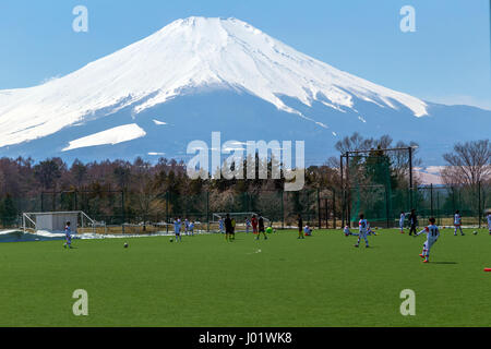 Mount Fuji towering over a football soccer pitch Stock Photo