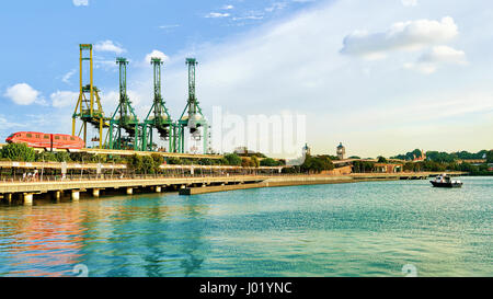 Passenger Express Train and loading cranes, Sentosa Island in Singapore. Port Container terminal on the background Stock Photo