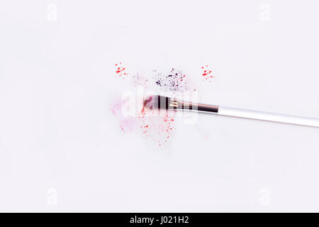 Multicolor crushed eye shadows isolated on white background. Stock Photo