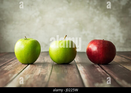 Dare to Be Different - Artistic Still Life of Two Green Apples and a Red. Stock Photo