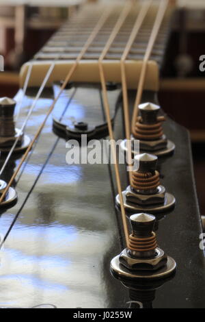 Six string guitar with shallow focus on tuning pegs Stock Photo