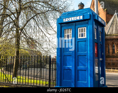 Old blue police box, Tardis, city centre street, Glasgow, Scotland, UK with red sandstone church in background, Scotland, UK Stock Photo