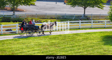 Lancaster, Pennsylvania - September 10, 2016 - Amish men give tourists a ride in a traditional buggy on a historic farm in Amish Country Pennsylvania. Stock Photo