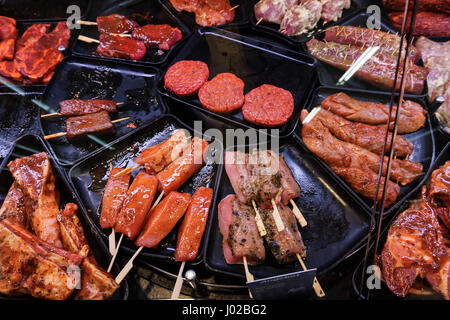 Marinaded meat for grilling in a counter display in a supermarket.  meat at the butcher Stock Photo