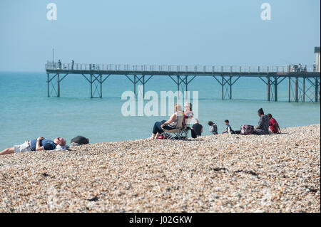 People sitting on chairs on the beach enjoying a sunny day in Bognor Regis, West Sussex, England. Stock Photo