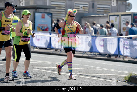 Brighton UK 9th April 2017 - A runner in fancy dress finds it hot work on the seafront in the Brighton Marathon today on a beautiful sunny warm day with temperatures reaching as high as 24 degrees celsius in some parts of the country  Photograph taken by Simon Dack Stock Photo