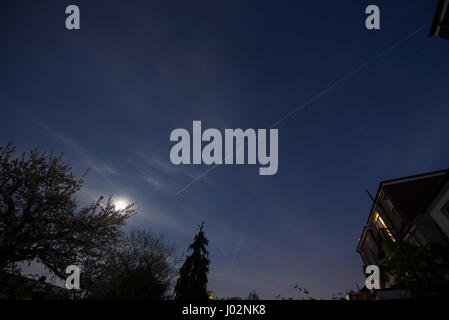 London, UK. 9th April 2017. The International Space Station travels over London at 17,500mph, crossing from west to south east and visible for a period of 4 minutes, passing under an almost full moon. Credit: Malcolm Park/Alamy Live News. Stock Photo