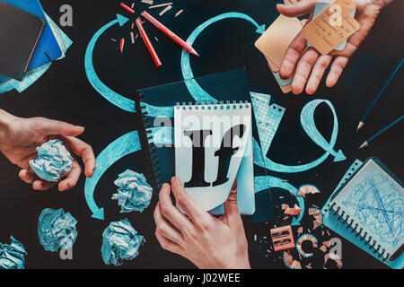 Conceptual still life with a mind-map drawn with chalk, notebook, crumpled paper balls and hands of a writer on a dark background Stock Photo