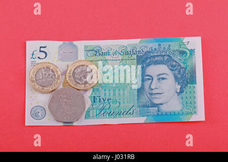 British, UK living wage of seven pounds and fifty pence came into force on the 1st April 2017. Photo taken against a red background. Stock Photo