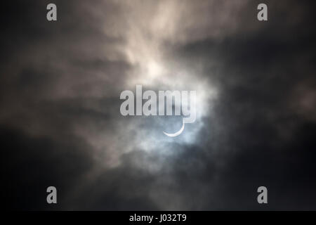Solar eclipse with the Sun partially covered by the Moon and surrounded by stormy clouds, 20th March 2015, Worcestershire, UK. Stock Photo