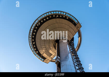 Madrid, Spain - April 7, 2017:  Low angle view of The Faro of Moncloa is a transmission tower with an observation deck in Madrid. It was designed by a Stock Photo