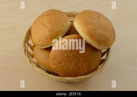 Wheat cocktail rolls in wood wicker bread basket Stock Photo