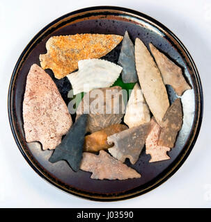 Plate full of real American indian arrowheads found in Texas and Missouri made around 7000 to 8000 years ago. Stock Photo