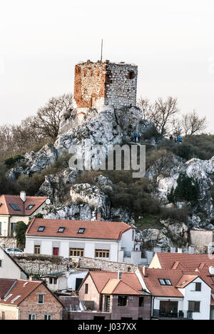 ruins of Kozi hradek castle with tourists and houses of Mikulov city bellow from Olivetska hora hill in southernmost part of Palava mountains in South Stock Photo